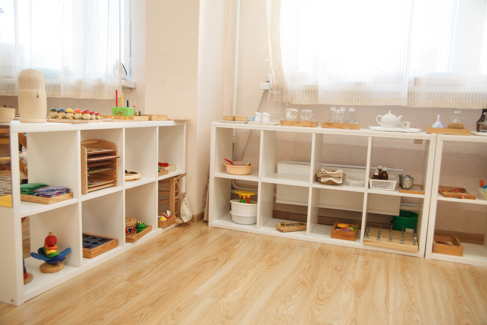 Shelving in a Montessori class with wood and glass material